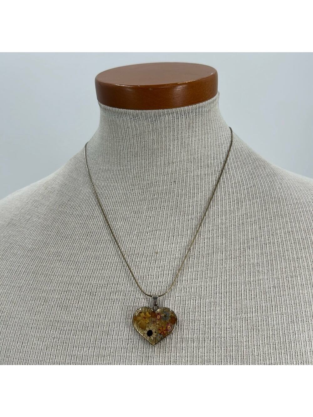 Sterling silver pressed flowered in a resin heart necklace